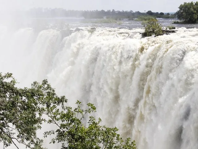 A close-up view of the powerful Victoria Falls cascading down a rocky edge.